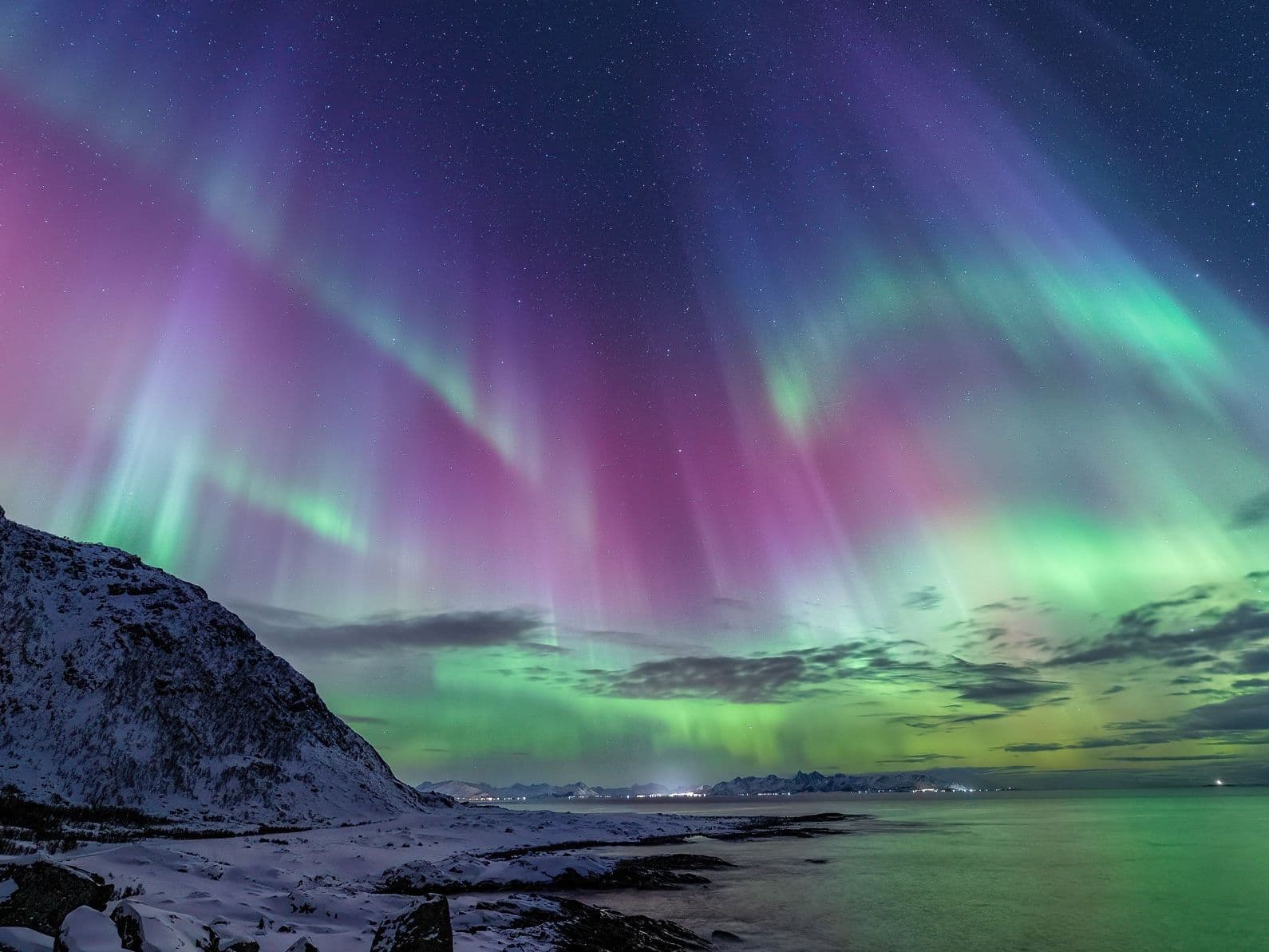 Aurora colors across a night landscape